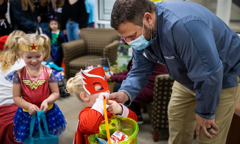 Children in costume trick or treat around school